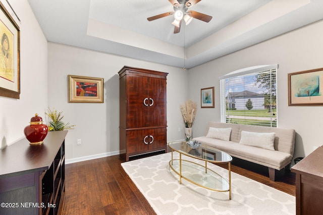 338 Deerfield Glen Dr, Saint Augustine, FL 32086 - living area featuring dark wood-style flooring, ceiling fan, and a tray ceiling