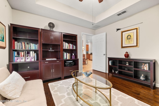 338 Deerfield Glen Dr, Saint Augustine, FL 32086 - living room featuring a raised ceiling, dark wood-style flooring, and a ceiling fan