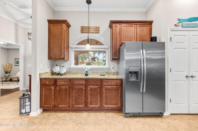 338 Deerfield Glen Dr, Saint Augustine, FL 32086 - kitchen featuring stainless steel fridge with ice dispenser, light stone countertops, brown cabinets, crown molding, and decorative light fixtures
