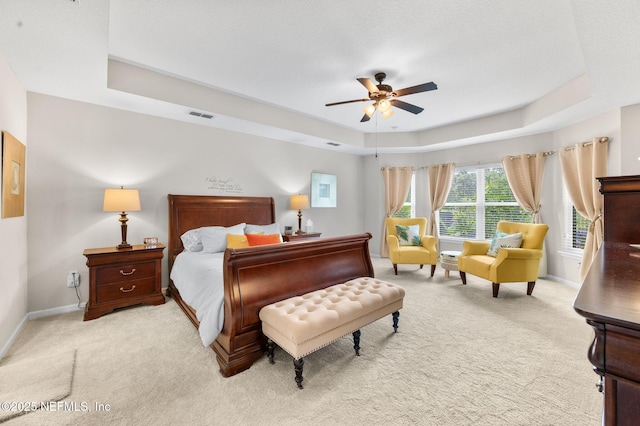 338 Deerfield Glen Dr, Saint Augustine, FL 32086 - bedroom featuring a tray ceiling, light carpet, and a ceiling fan