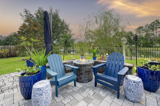 338 Deerfield Glen Dr, Saint Augustine, FL 32086 - patio terrace at dusk with an outdoor fire pit, a patio, and a fenced backyard