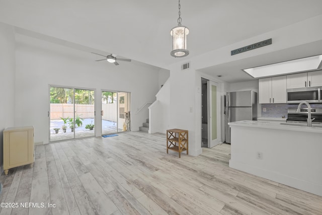 1206 Mayport Landing Cir, Jacksonville, FL 32233 - living room with stairway, light wood-type flooring, and ceiling fan