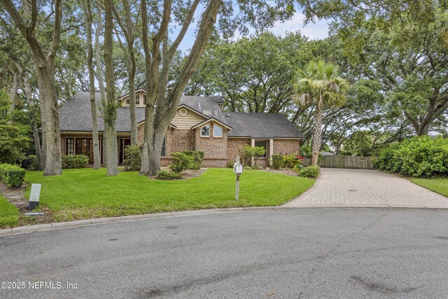 521 Birch Ct, Neptune Beach, FL 32266 - mid-century modern home with brick siding, decorative driveway, and roof with shingles