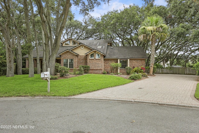521 Birch Ct, Neptune Beach, FL 32266 - view of front facade with decorative driveway, brick siding, and roof with shingles