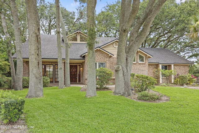 521 Birch Ct, Neptune Beach, FL 32266 - mid-century inspired home with roof with shingles, brick siding, and a front lawn