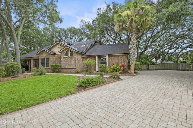 521 Birch Ct, Neptune Beach, FL 32266 - view of front facade with decorative driveway, brick siding, and roof with shingles