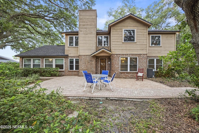 521 Birch Ct, Neptune Beach, FL 32266 - rear view of house featuring a chimney, a patio area, and brick siding