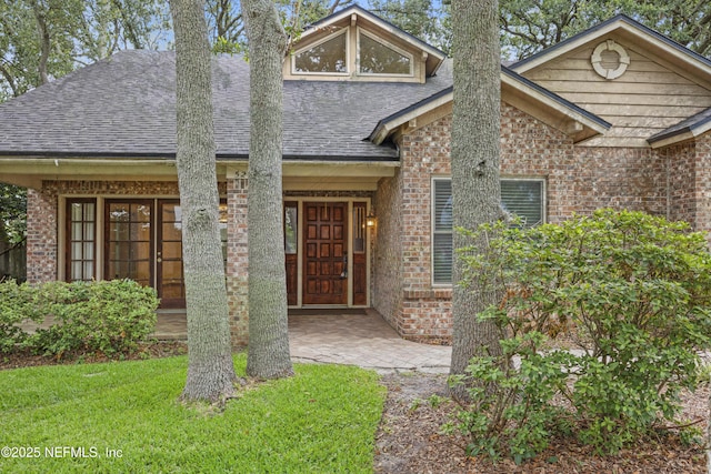 521 Birch Ct, Neptune Beach, FL 32266 - view of front of home featuring brick siding, a shingled roof, and a front yard