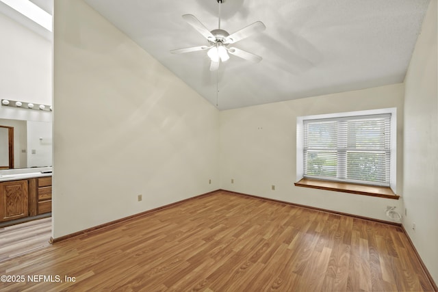 521 Birch Ct, Neptune Beach, FL 32266 - unfurnished bedroom featuring light wood-type flooring, lofted ceiling, ensuite bath, and ceiling fan