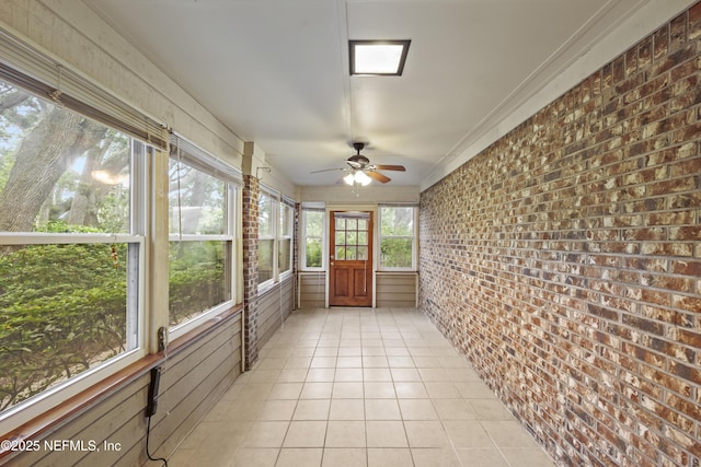521 Birch Ct, Neptune Beach, FL 32266 - unfurnished sunroom with ceiling fan, brick wall, tile patterned floors, and ornamental molding