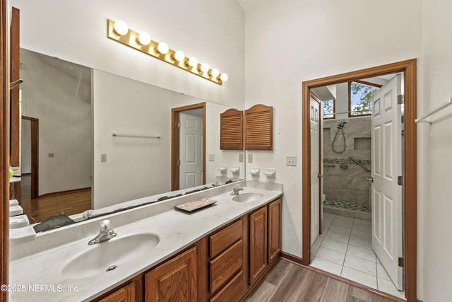 521 Birch Ct, Neptune Beach, FL 32266 - bathroom featuring double vanity, wood finished floors, and a high ceiling