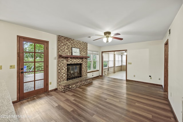 521 Birch Ct, Neptune Beach, FL 32266 - unfurnished living room featuring plenty of natural light, wood finished floors, ceiling fan, and a fireplace