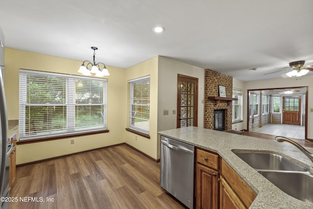 521 Birch Ct, Neptune Beach, FL 32266 - kitchen featuring dishwasher, a brick fireplace, light wood-type flooring, ceiling fan, and recessed lighting