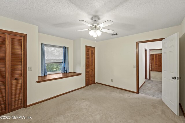 521 Birch Ct, Neptune Beach, FL 32266 - unfurnished bedroom featuring light colored carpet, ceiling fan, and a textured ceiling