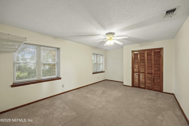 521 Birch Ct, Neptune Beach, FL 32266 - unfurnished bedroom with carpet floors, a closet, a ceiling fan, and a textured ceiling