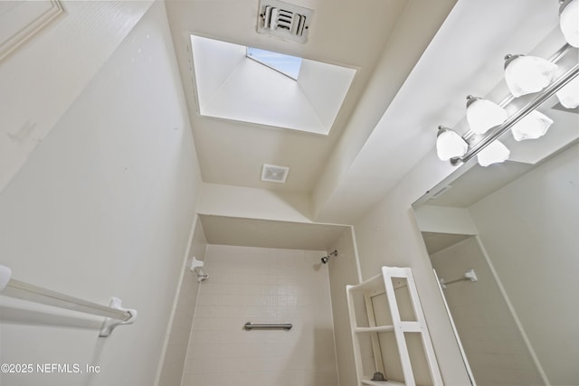 521 Birch Ct, Neptune Beach, FL 32266 - bathroom with tiled shower and a skylight