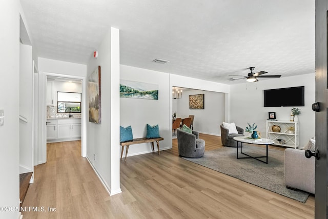1900 Dalamon St, Jacksonville, FL 32211 - living area featuring light wood-type flooring, a ceiling fan, and a textured ceiling