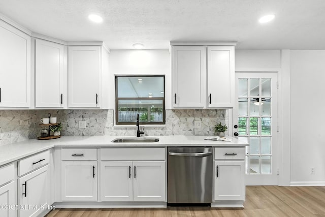 1900 Dalamon St, Jacksonville, FL 32211 - kitchen featuring dishwasher, light wood-type flooring, decorative backsplash, white cabinets, and recessed lighting