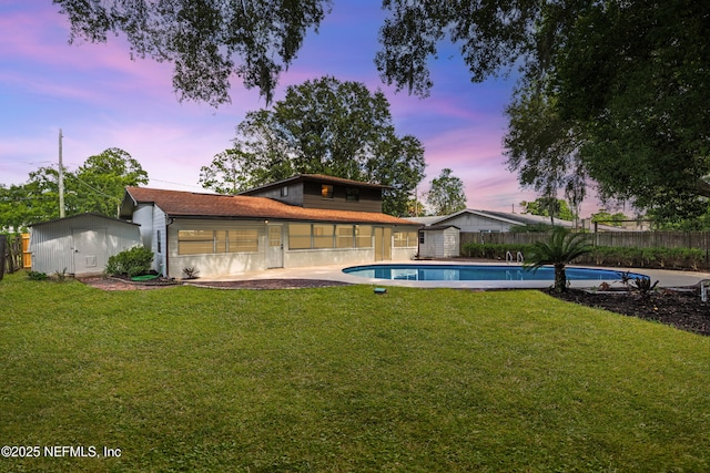 1900 Dalamon St, Jacksonville, FL 32211 - pool at dusk featuring a storage shed and a fenced backyard