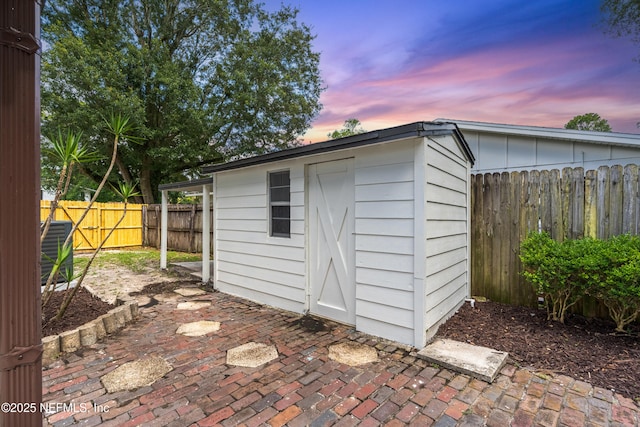 1900 Dalamon St, Jacksonville, FL 32211 - outdoor structure at dusk featuring a fenced backyard and a storage unit