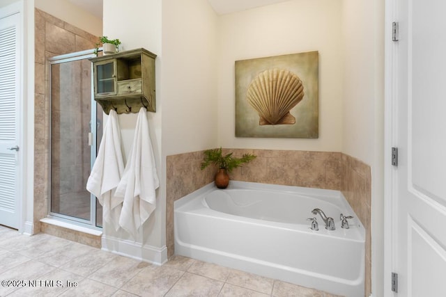4300 S Beach Pkwy Unit 3206, Jacksonville Beach, FL 32250 - full bathroom featuring a bath, a shower stall, and tile patterned floors