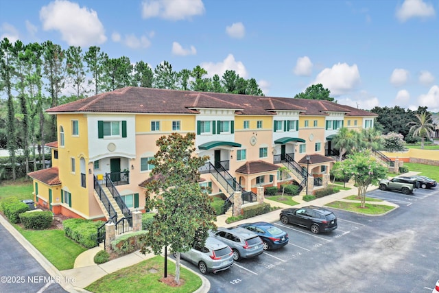 9745 Touchton Rd Unit 121, Jacksonville, FL 32246 - view of property with uncovered parking and stairs