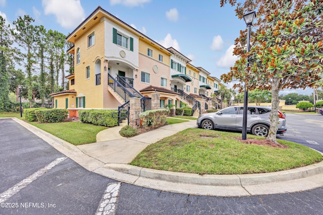 9745 Touchton Rd Unit 121, Jacksonville, FL 32246 - view of building exterior featuring stairs and a residential view