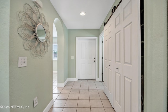 9745 Touchton Rd Unit 121, Jacksonville, FL 32246 - hallway with arched walkways, light tile patterned flooring, and recessed lighting