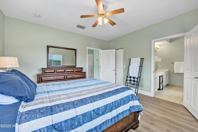 9745 Touchton Rd Unit 121, Jacksonville, FL 32246 - bedroom featuring light wood-type flooring, ensuite bath, and a ceiling fan