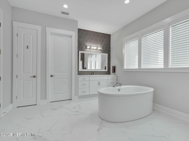 32 Awlleaf Ct, Saint Augustine, FL 32095 - full bathroom featuring a freestanding bath, marble finish flooring, vanity, recessed lighting, and tile walls