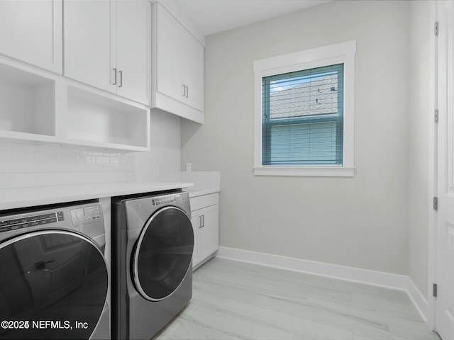 32 Awlleaf Ct, Saint Augustine, FL 32095 - washroom featuring cabinet space, washer and dryer, and light marble finish floors
