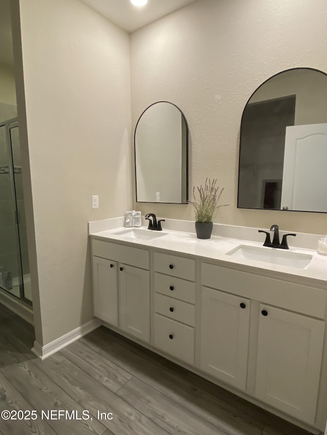 66 Tree Frog Way, Saint Augustine, FL 32095 - bathroom with double vanity, wood finished floors, and a shower stall