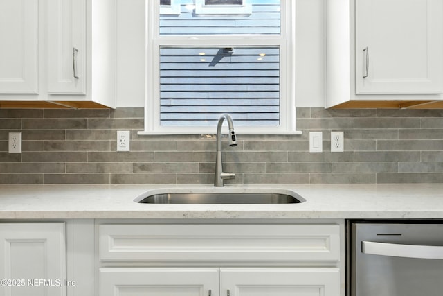81 Glenhurst Ave, Ponte Vedra, FL 32081 - kitchen with dishwasher, white cabinetry, tasteful backsplash, and light stone counters