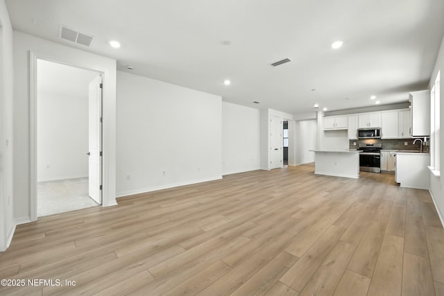 81 Glenhurst Ave, Ponte Vedra, FL 32081 - unfurnished living room with light wood-type flooring and recessed lighting