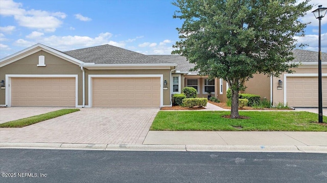 11725 Surfbird Cir Unit 4C, Jacksonville, FL 32256 - ranch-style house featuring stucco siding, an attached garage, driveway, and a front yard