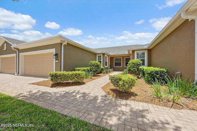 11725 Surfbird Cir Unit 4C, Jacksonville, FL 32256 - ranch-style house with stucco siding, a garage, and decorative driveway