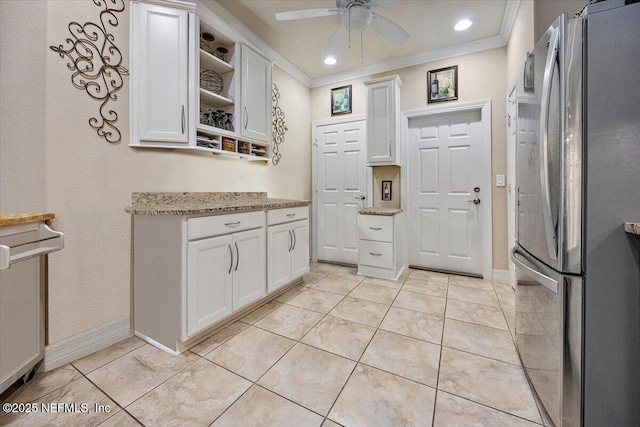 11725 Surfbird Cir Unit 4C, Jacksonville, FL 32256 - kitchen with freestanding refrigerator, crown molding, a ceiling fan, white cabinetry, and light stone countertops