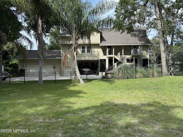 3793 Forest Dr, Middleburg, FL 32068 - rear view of property featuring an attached garage, a fenced front yard, stairway, and a shingled roof