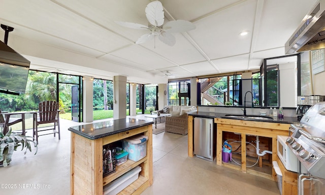 3793 Forest Dr, Middleburg, FL 32068 - kitchen with fridge, a ceiling fan, dark countertops, finished concrete floors, and ventilation hood