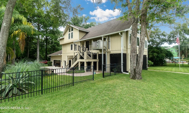 3793 Forest Dr, Middleburg, FL 32068 - rear view of property with a fenced backyard, a balcony, stairs, a shingled roof, and a garage