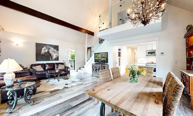 3793 Forest Dr, Middleburg, FL 32068 - dining room with high vaulted ceiling, stairway, wood finished floors, a chandelier, and beam ceiling