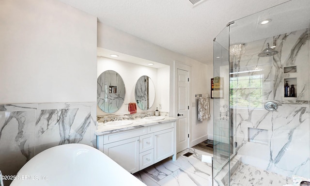 3793 Forest Dr, Middleburg, FL 32068 - full bath featuring marble tiled flooring, a marble finish shower, double vanity, a freestanding bath, and recessed lighting