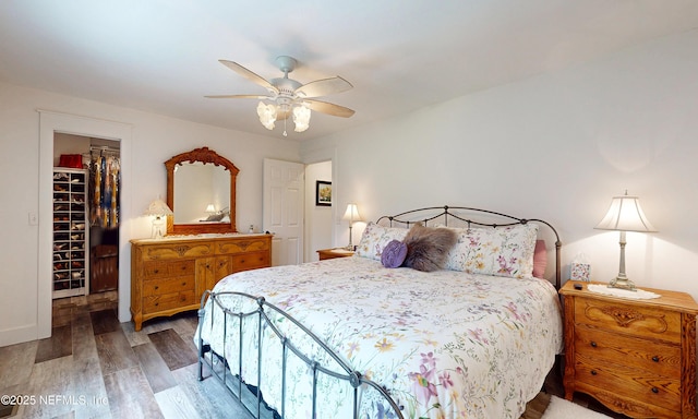 3793 Forest Dr, Middleburg, FL 32068 - bedroom featuring a walk in closet, light wood-style floors, and ceiling fan