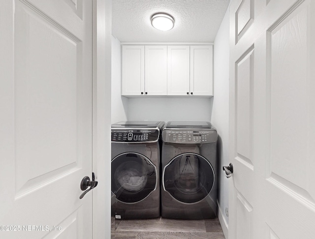 3793 Forest Dr, Middleburg, FL 32068 - laundry area featuring separate washer and dryer, wood finished floors, cabinet space, and a textured ceiling