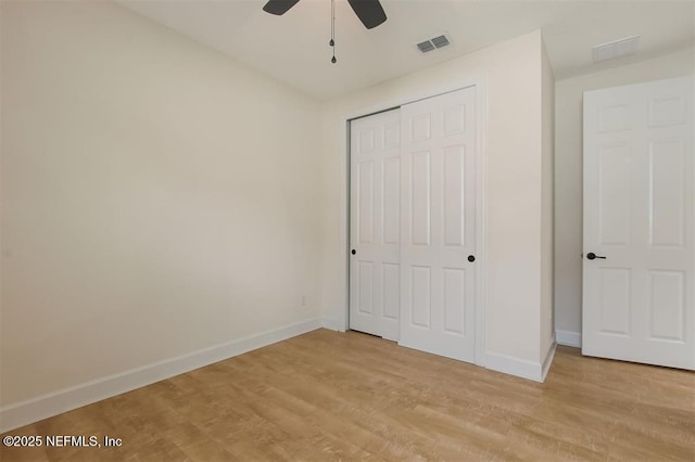 85212 Champlain Dr, Fernandina Beach, FL 32034 - unfurnished bedroom with a closet, light wood-style flooring, and a ceiling fan