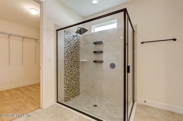 85212 Champlain Dr, Fernandina Beach, FL 32034 - bathroom featuring a shower stall, a spacious closet, and tile patterned floors