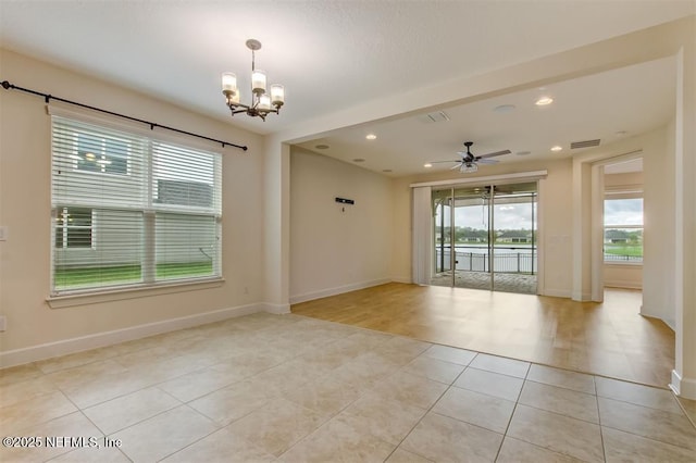 85212 Champlain Dr, Fernandina Beach, FL 32034 - empty room with a chandelier, light tile patterned floors, ceiling fan, recessed lighting, and a water view