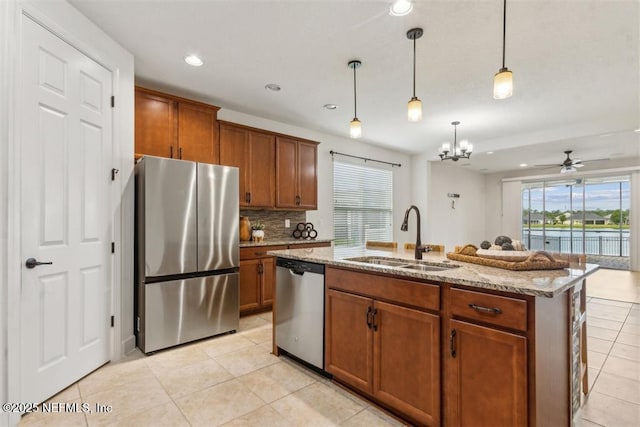 85212 Champlain Dr, Fernandina Beach, FL 32034 - kitchen featuring stainless steel appliances, brown cabinets, light stone counters, and recessed lighting