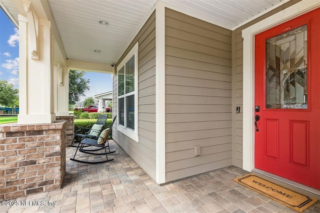 85212 Champlain Dr, Fernandina Beach, FL 32034 - view of exterior entry with a porch