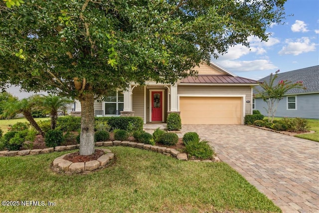 85212 Champlain Dr, Fernandina Beach, FL 32034 - view of front of house with a standing seam roof, an attached garage, driveway, a front yard, and a metal roof